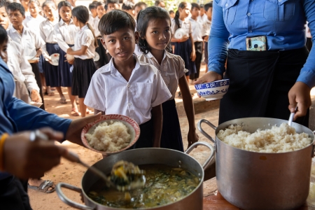 Children from the Bos Thom school near Siem Reap queue up for lunch at their school.